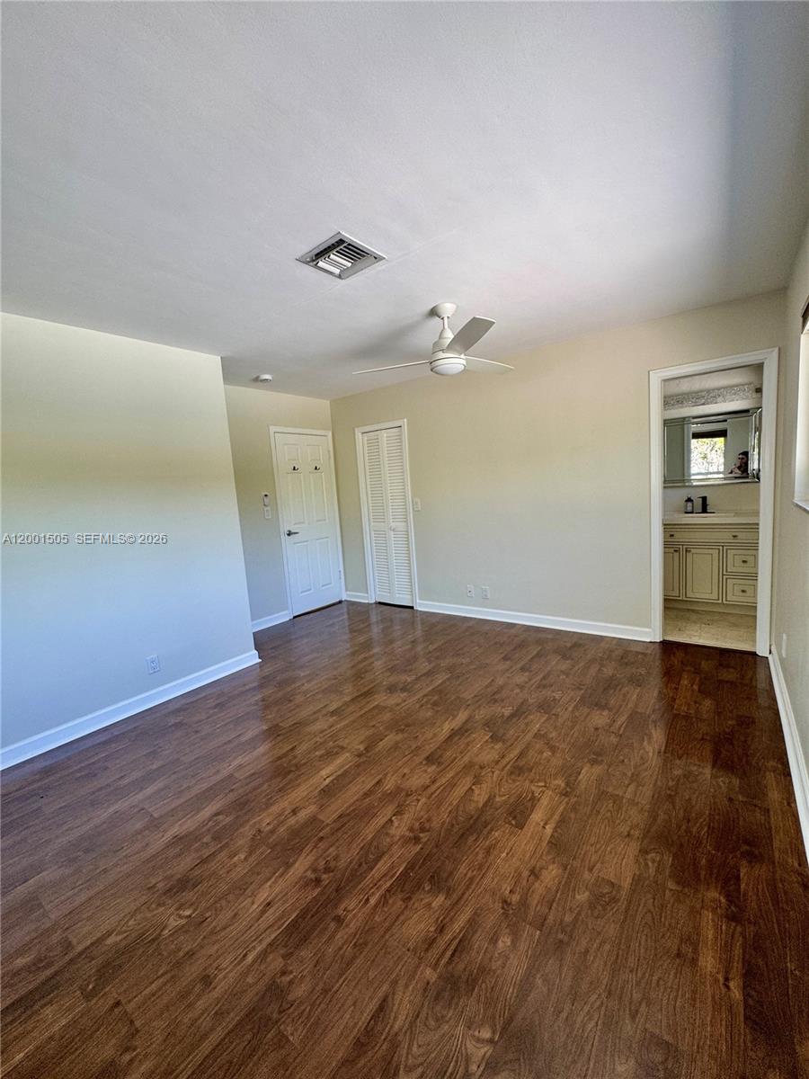 1093 Southwest 14th Street Boca Raton, FL 33486 - Photo 12 of 28 an empty room with wooden floor and windows