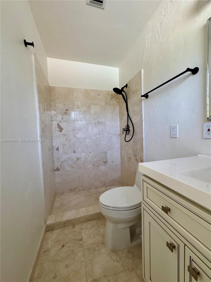 1093 Southwest 14th Street Boca Raton, FL 33486 - Photo 15 of 28 a bathroom with a sink a toilet and shower