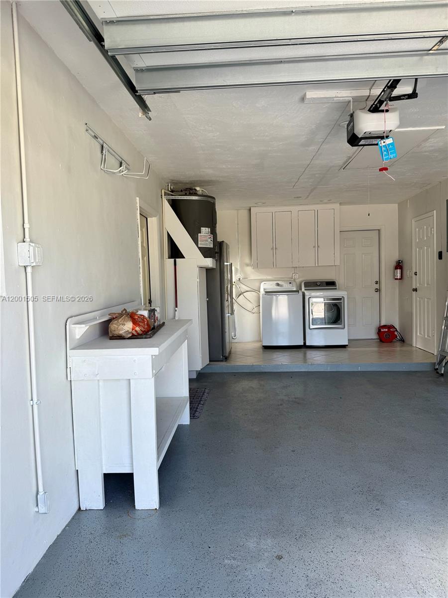 1093 Southwest 14th Street Boca Raton, FL 33486 - Photo 20 of 28 a kitchen with refrigerator and cabinets