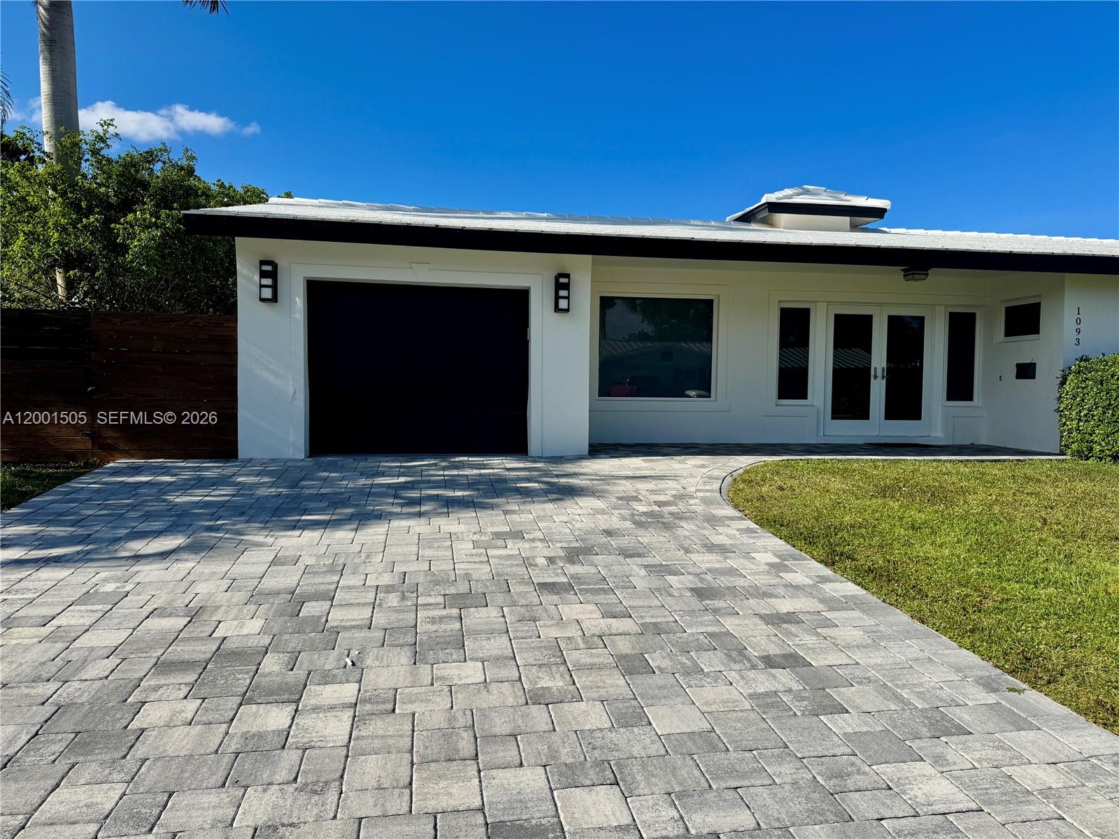 1093 Southwest 14th Street Boca Raton, FL 33486 - Photo 22 of 28 a front view of a house with a yard
