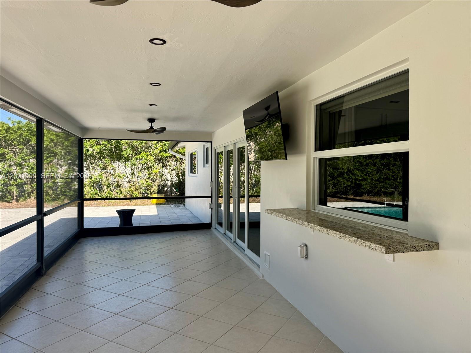 1093 Southwest 14th Street Boca Raton, FL 33486 - Photo 23 of 28 a view of hallway with furniture and a window