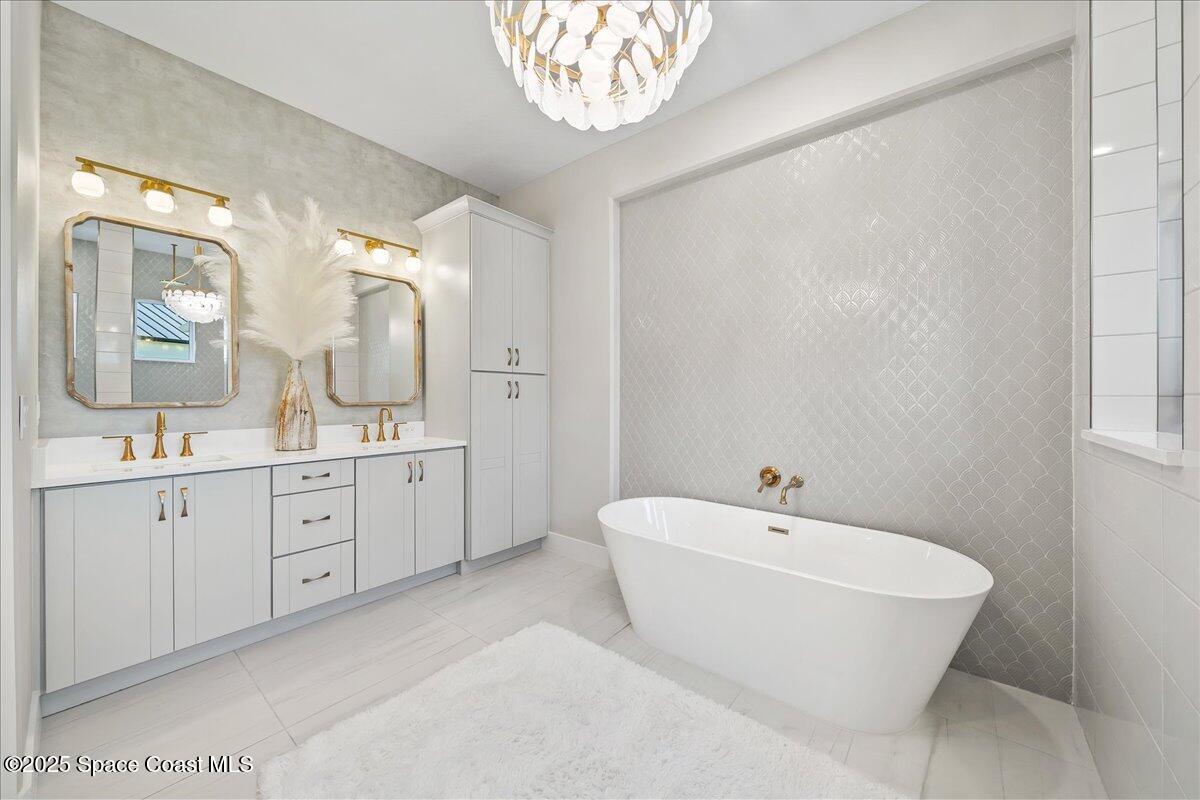 7953 Galikova Way Melbourne, FL 32940 - Photo 14 of 17 a spacious bathroom with 2 sink toilet and a mirror