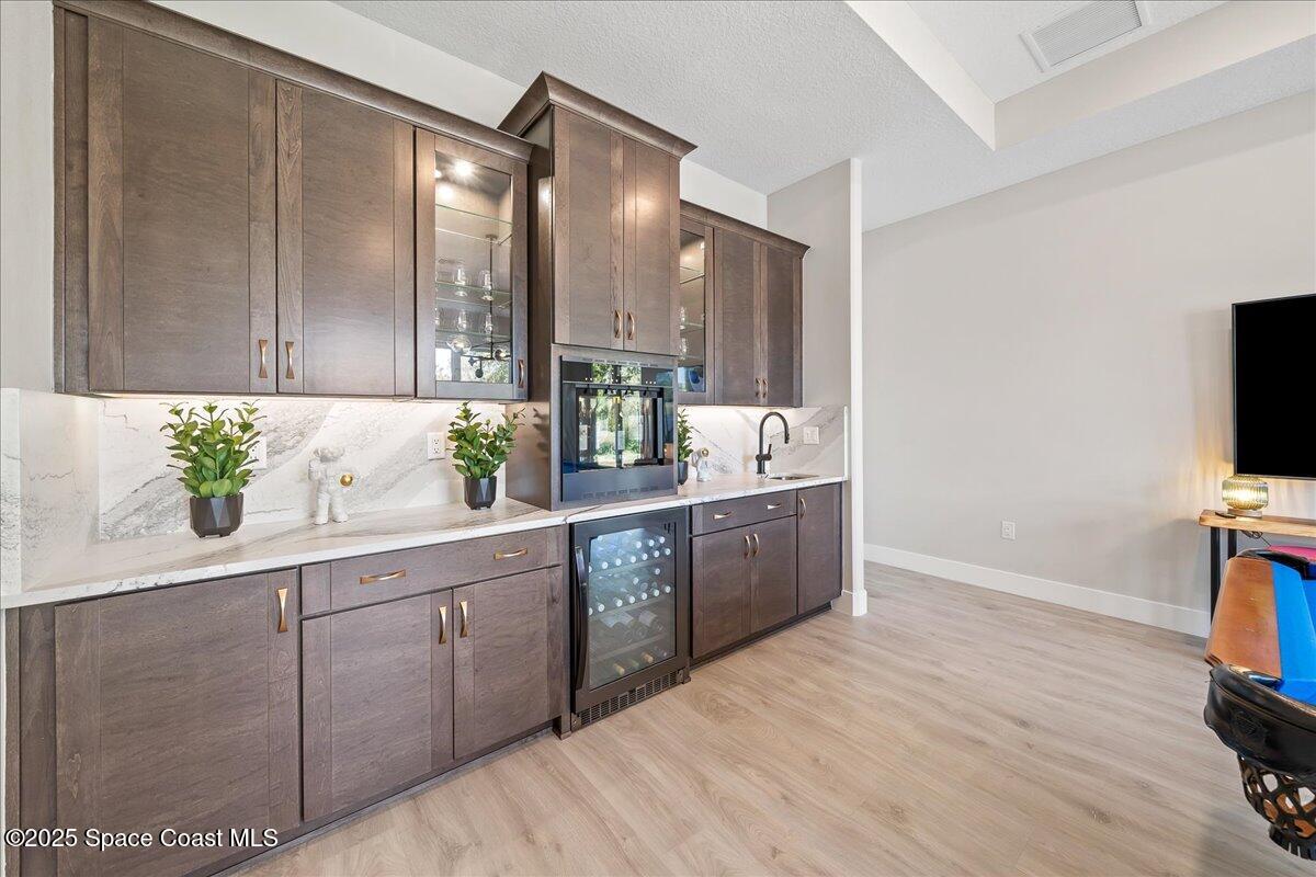 7953 Galikova Way Melbourne, FL 32940 - Photo 16 of 17 a spacious bathroom with a double vanity sink a mirror and a shower