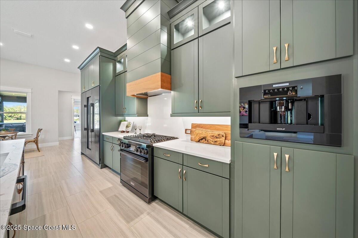 7953 Galikova Way Melbourne, FL 32940 - Photo 10 of 17 a kitchen with stainless steel appliances granite countertop a lot of counter space and wooden floors