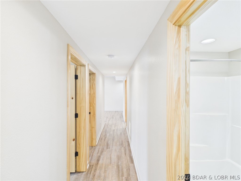 6055 McCasland Road Versailles, MO 65084 - Photo 62 of 99 basement hall leading to bedrooms from lower garag