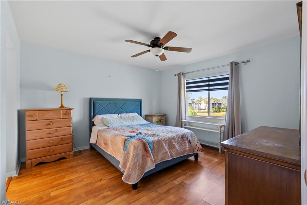 121 Gabriel Circle, Unit 1108 Naples, FL 34104 - Photo 15 of 41 a bedroom with a bed and a window