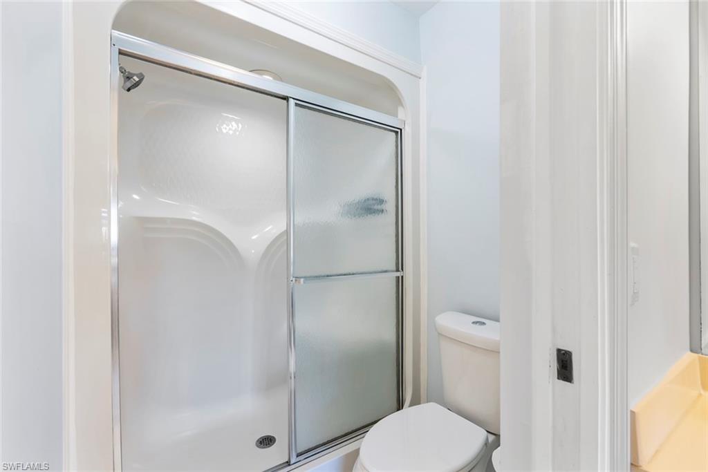 121 Gabriel Circle, Unit 1108 Naples, FL 34104 - Photo 20 of 41 a bathroom with a shower and toilet