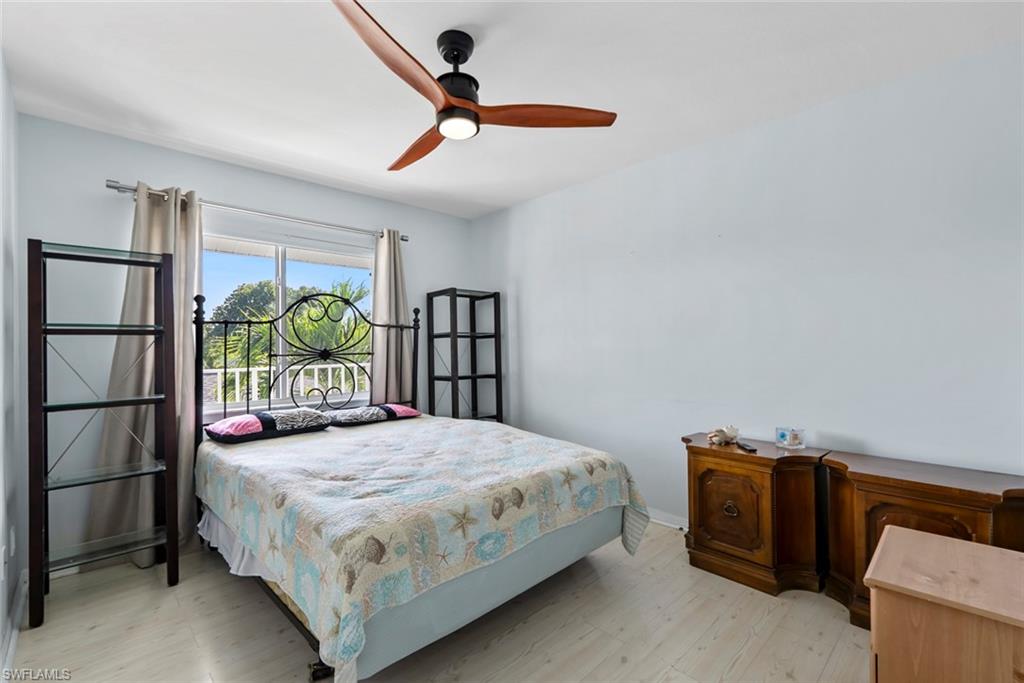 121 Gabriel Circle, Unit 1108 Naples, FL 34104 - Photo 23 of 41 a bedroom with a bed and a window