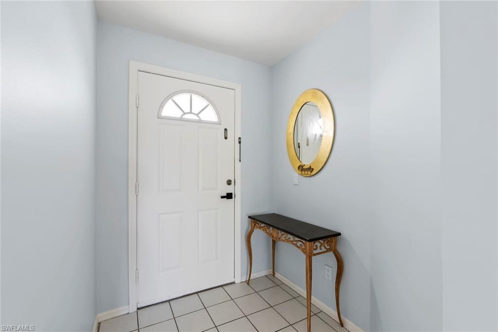 121 Gabriel Circle, Unit 1108 Naples, FL 34104 - Photo 4 of 41 a bathroom with a toilet and a mirror