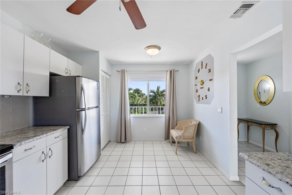 121 Gabriel Circle, Unit 1108 Naples, FL 34104 - Photo 9 of 41 a kitchen with a refrigerator and countertop