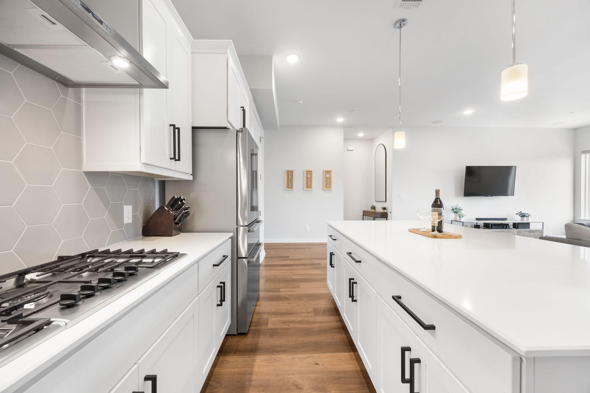 1417 Kramer Lane, Unit 14 Austin, TX 78758 - Photo 33 of 33 Kitchen with ventilation hood, white cabinetry, stainless steel appliances, and open floor plan