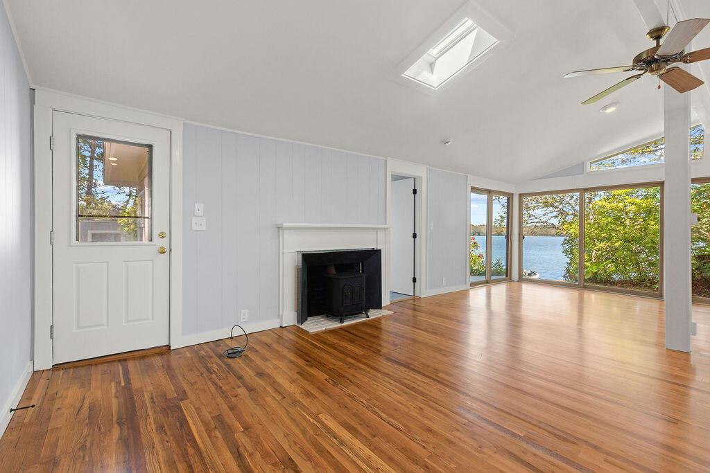 35 Santuit Lane Mashpee, MA 02649 - Photo 13 of 51 a view of an empty room with a window and wooden floor