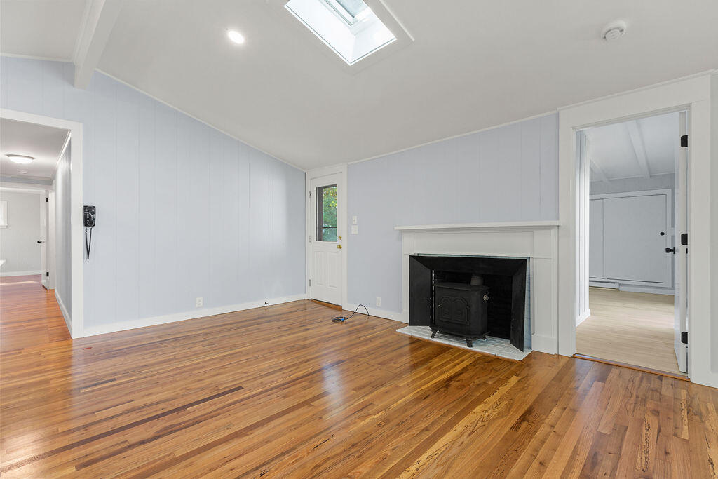 35 Santuit Lane Mashpee, MA 02649 - Photo 14 of 51 a view of an empty room with wooden floor fireplace and a window