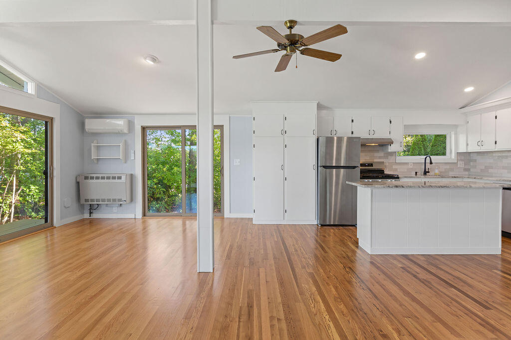 35 Santuit Lane Mashpee, MA 02649 - Photo 20 of 51 a kitchen with stainless steel appliances a refrigerator a sink dishwasher and a stove with wooden floor