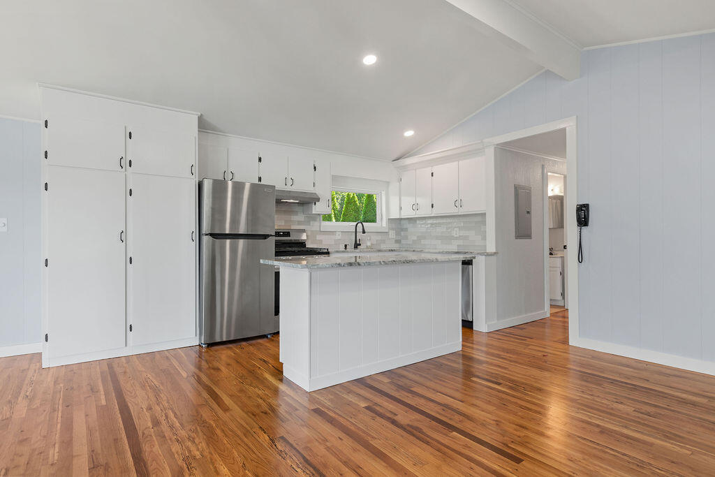 35 Santuit Lane Mashpee, MA 02649 - Photo 21 of 51 a kitchen with stainless steel appliances granite countertop a refrigerator sink and white cabinets