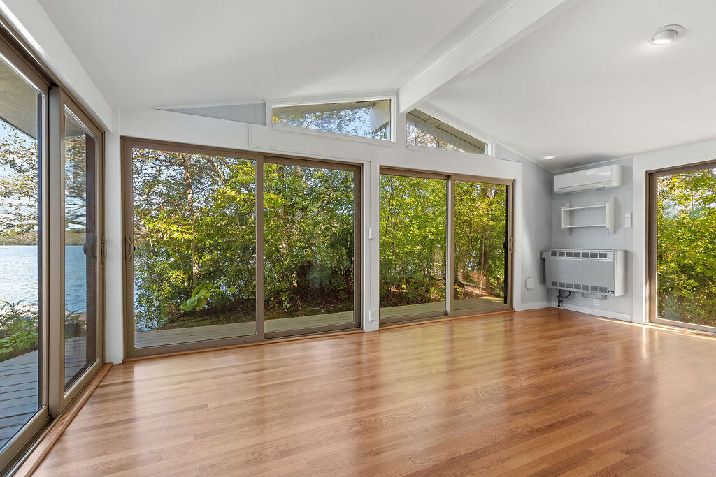 35 Santuit Lane Mashpee, MA 02649 - Photo 27 of 51 an empty room with wooden floor and windows