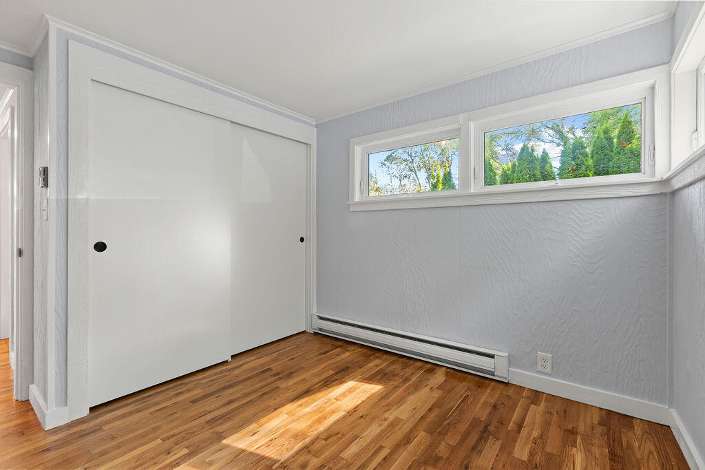 35 Santuit Lane Mashpee, MA 02649 - Photo 38 of 51 a view of an empty room with wooden floor and a window