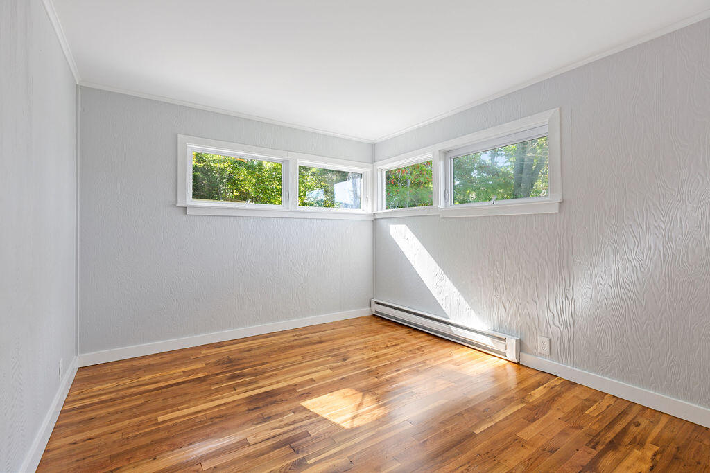 35 Santuit Lane Mashpee, MA 02649 - Photo 41 of 51 an empty room with wooden floor and windows