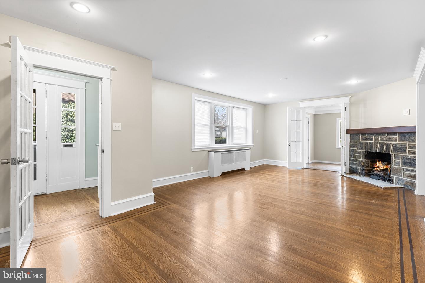 103 Llandaff Road Havertown, PA 19083 - Photo 3 of 36 a view of empty room with wooden floor and fireplace