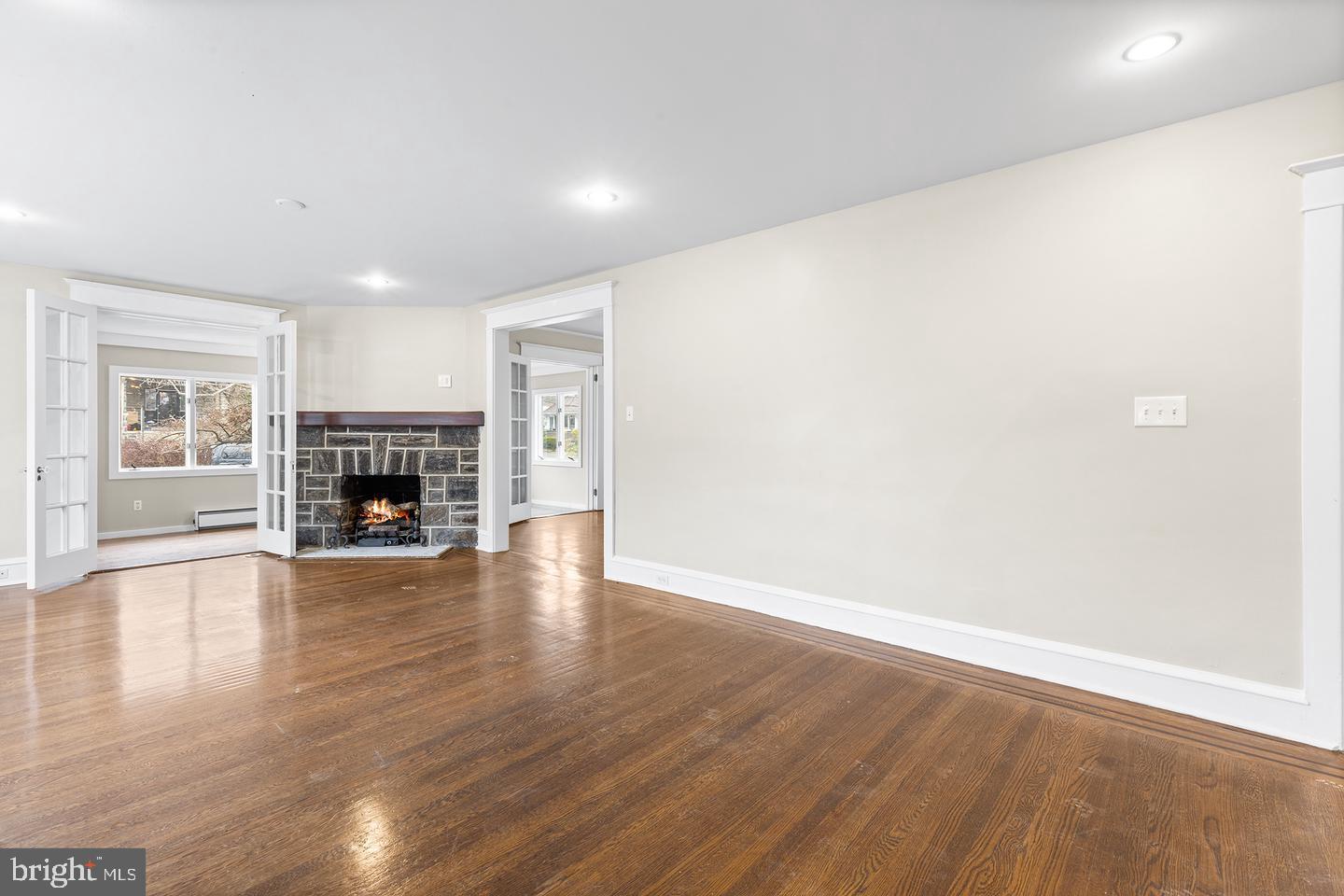 103 Llandaff Road Havertown, PA 19083 - Photo 4 of 36 a view of empty room with fireplace and wooden floor