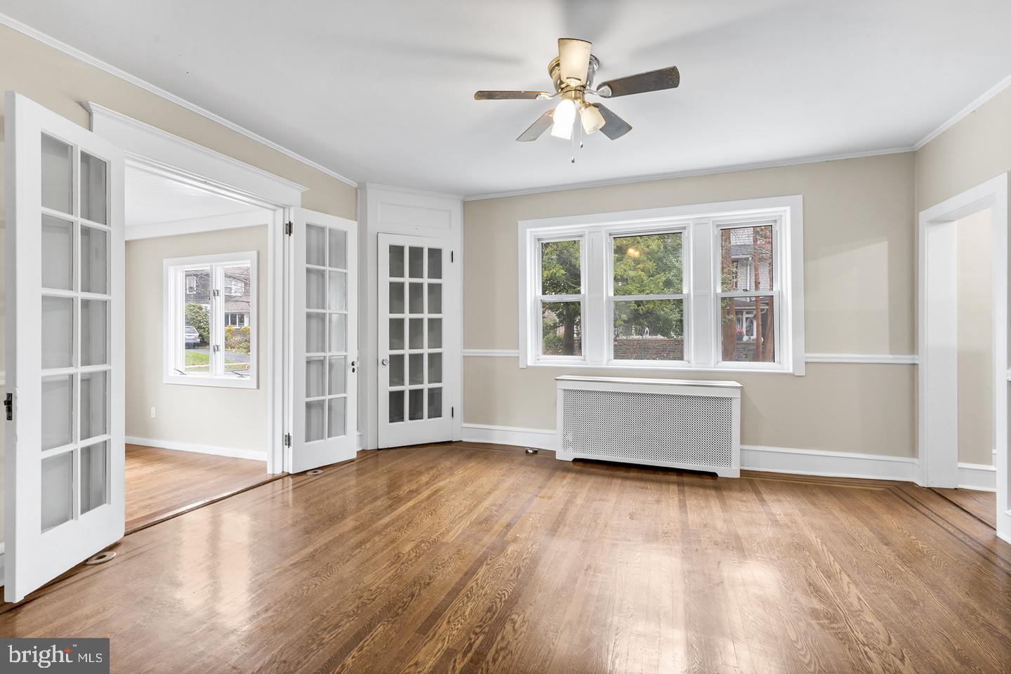 103 Llandaff Road Havertown, PA 19083 - Photo 7 of 36 an empty room with wooden floor and windows