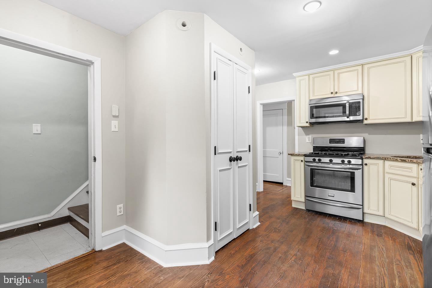 103 Llandaff Road Havertown, PA 19083 - Photo 8 of 36 a kitchen with stainless steel appliances a stove a microwave and a hard wood floors