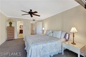 1 Bluebill Avenue, Unit 707 Naples, FL 34108 - Photo 9 of 16 Bedroom featuring ceiling fan and dark colored carpet