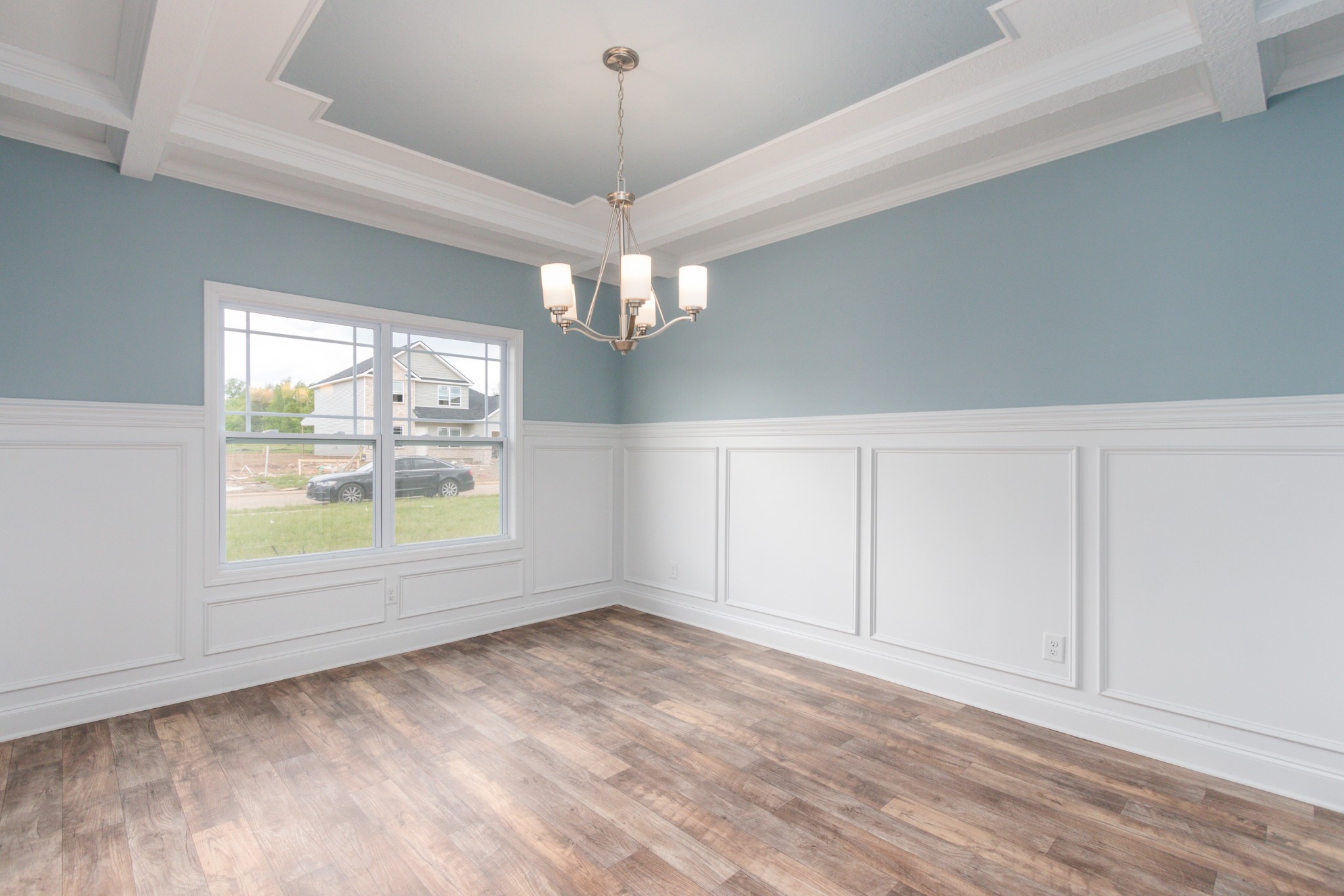 100 Murrell Road Dickson, TN 37055 - Photo 3 of 17 an empty room with wooden floor chandelier and windows