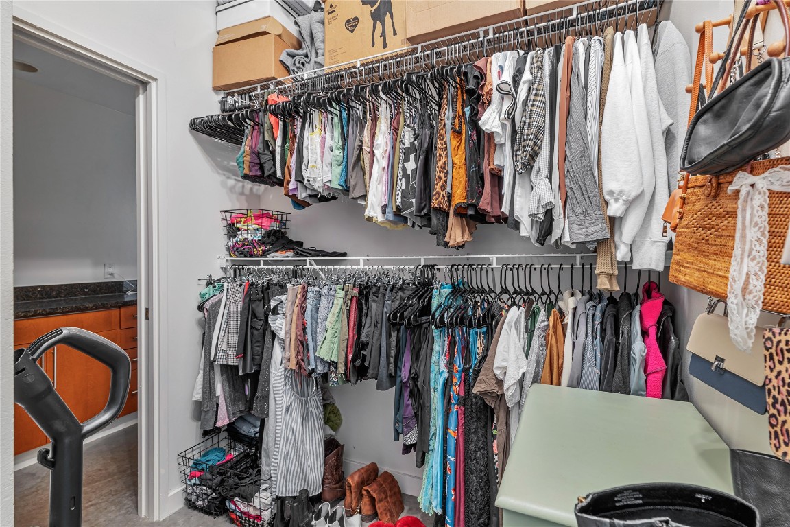 2124 East 6th Street, Unit 305 Austin, TX 78702 - Photo 17 of 35 a view of walk in closet with clothes and shoes