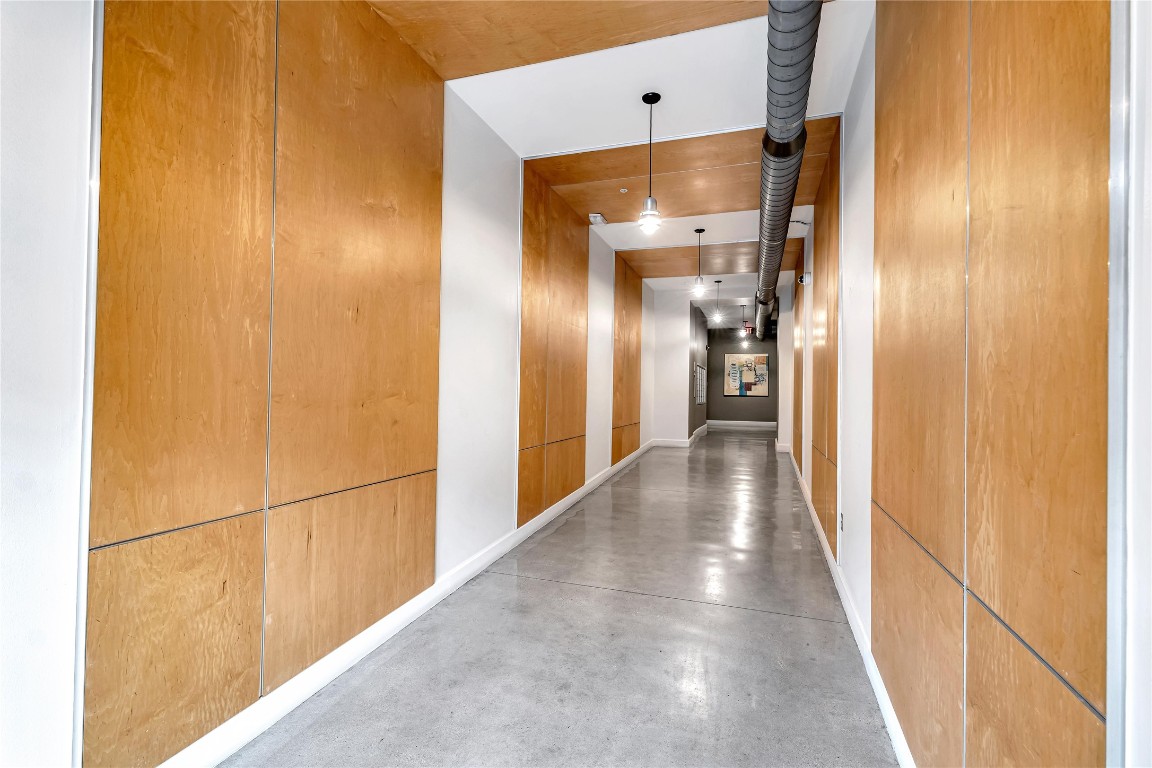 2124 East 6th Street, Unit 305 Austin, TX 78702 - Photo 4 of 35 a view of a hallway with wooden floor