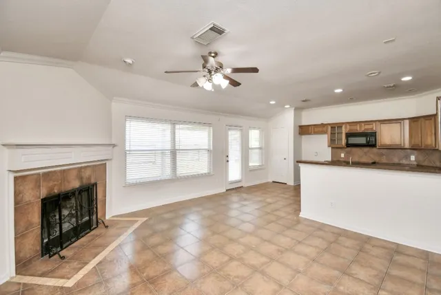 a large kitchen with granite countertop a stove top oven sink and cabinets