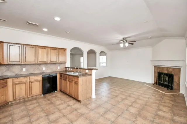 a large kitchen with stainless steel appliances granite countertop a stove and a refrigerator