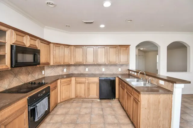 an empty room with closet and fan