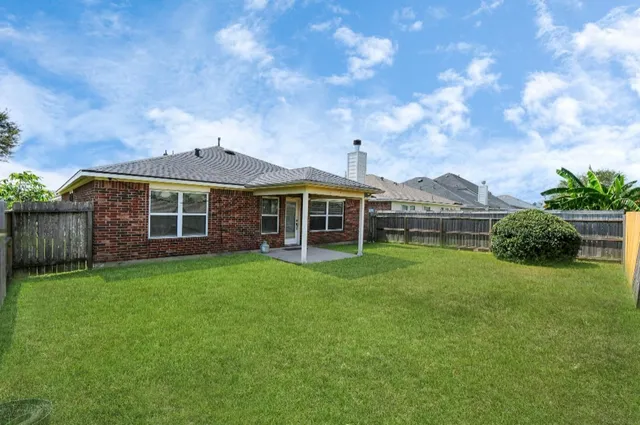 a view of a backyard with plants and a backyard
