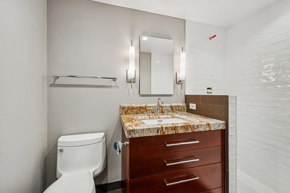 100 East Huron Street, Unit 2903 Chicago, IL 60611 - Photo 8 of 17 a bathroom with a sink toilet and mirror
