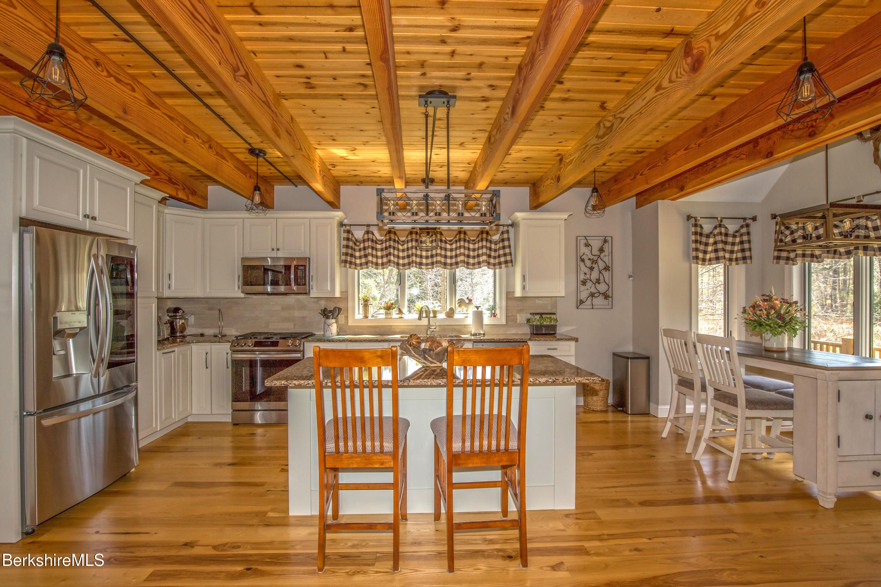 24 Evergreen Drive Otis, MA 01253 - Photo 12 of 41 a view of a dining room with furniture window and wooden floor