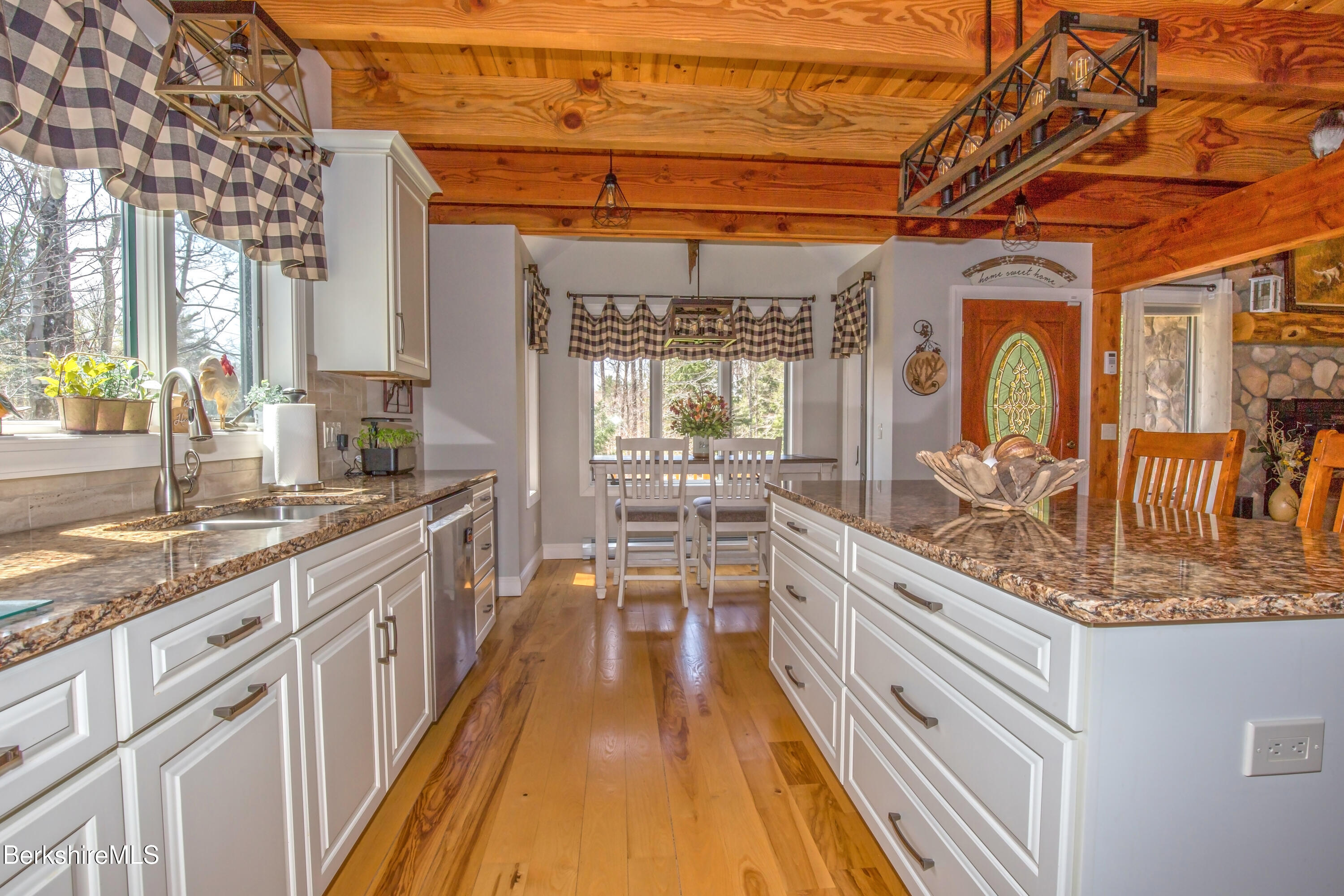 24 Evergreen Drive Otis, MA 01253 - Photo 13 of 41 a large kitchen with kitchen island granite countertop a large window and stainless steel appliances