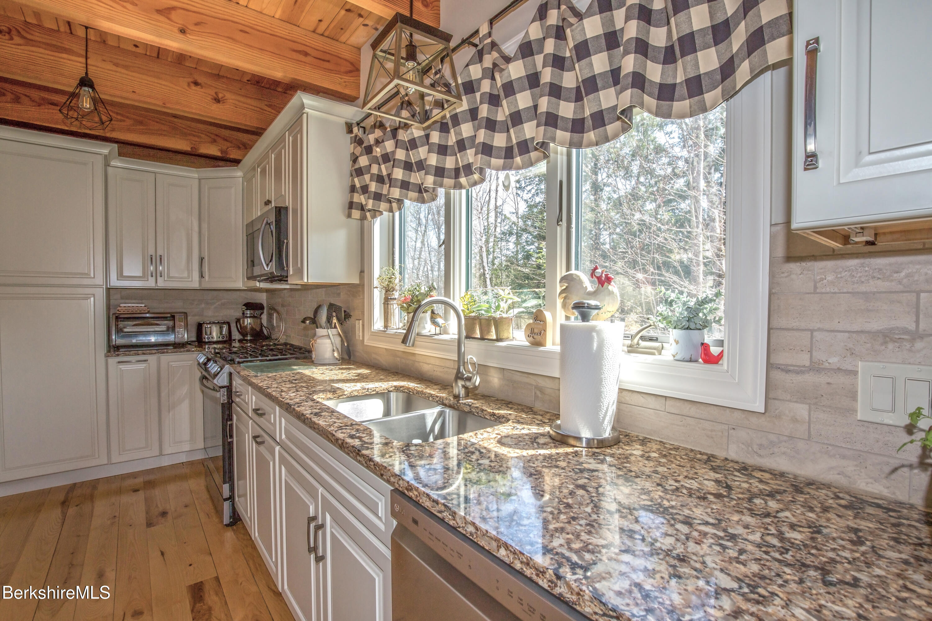 24 Evergreen Drive Otis, MA 01253 - Photo 17 of 41 a kitchen with stainless steel appliances granite countertop a sink and a stove