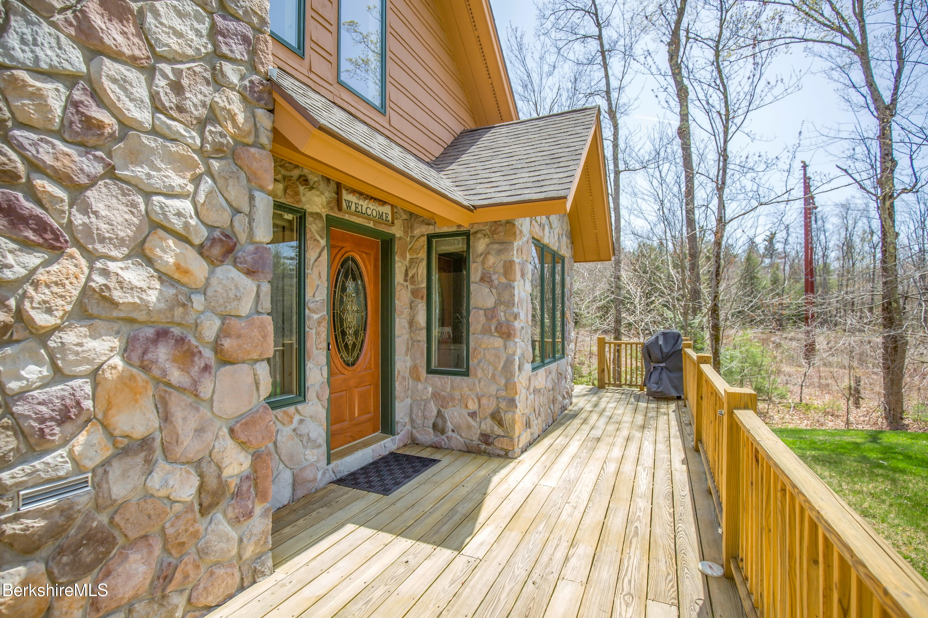 24 Evergreen Drive Otis, MA 01253 - Photo 3 of 41 a view of a brick house with many windows