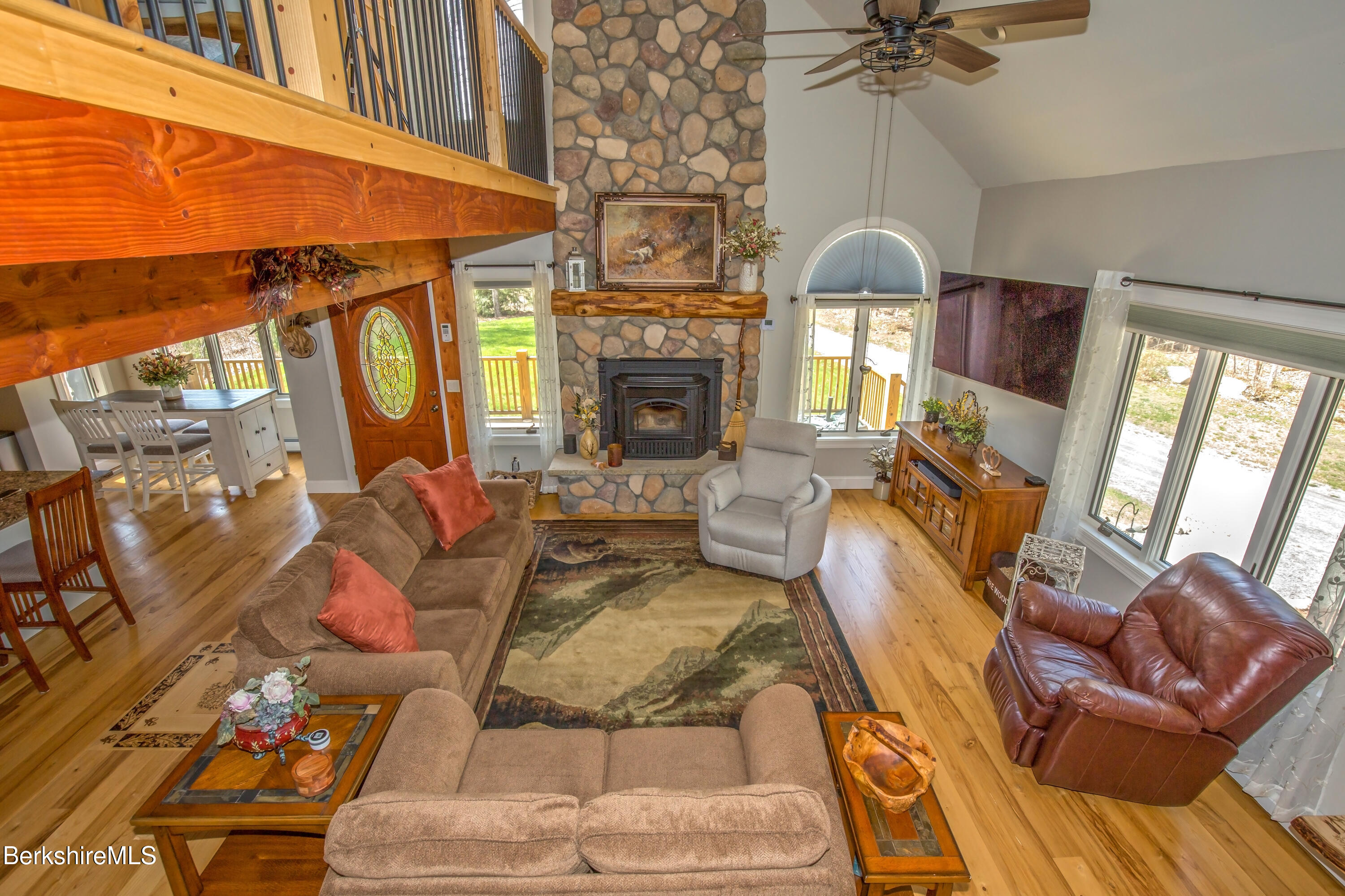 24 Evergreen Drive Otis, MA 01253 - Photo 31 of 41 a living room with furniture a fireplace and a floor to ceiling window