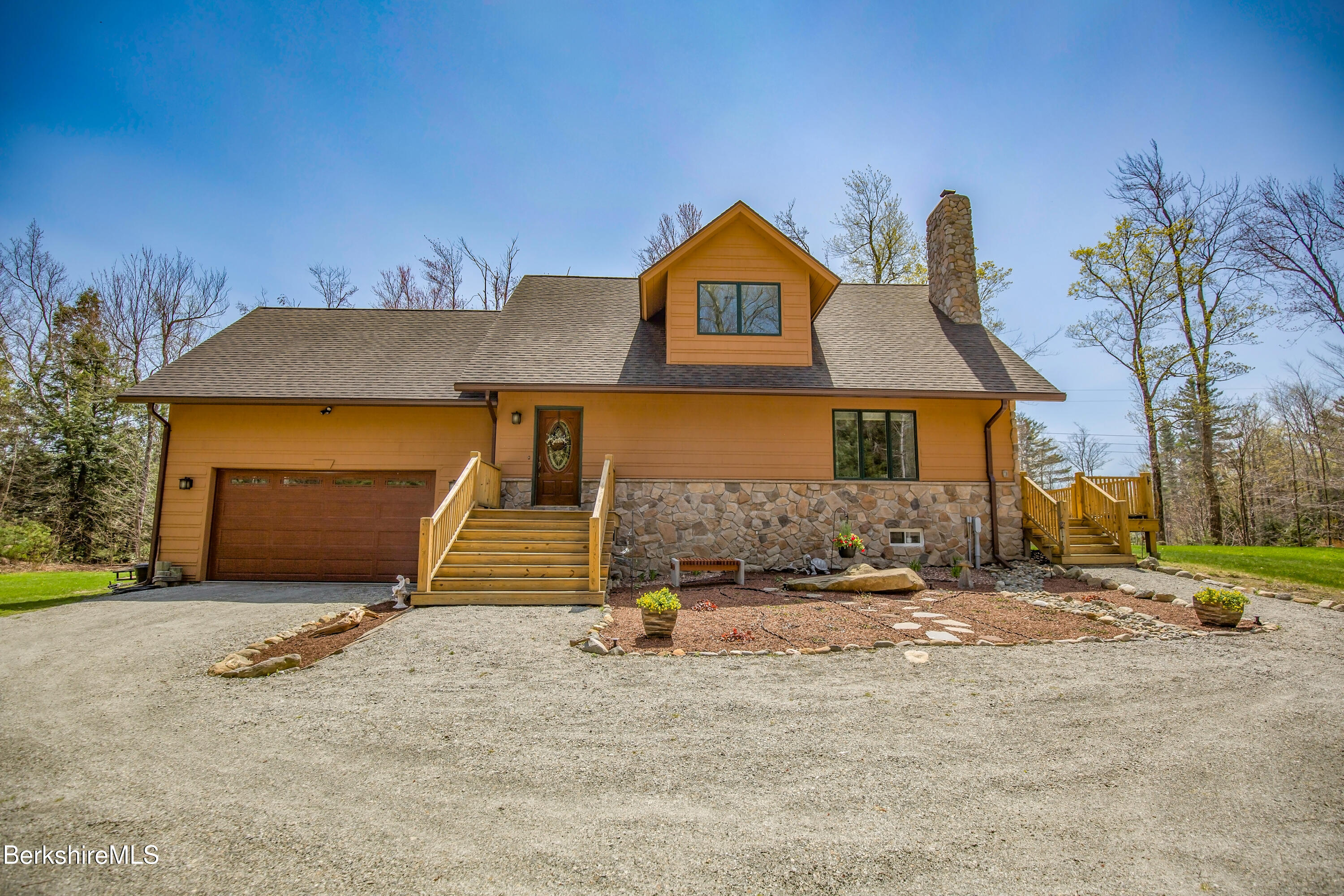 24 Evergreen Drive Otis, MA 01253 - Photo 5 of 41 a front view of a house with a yard