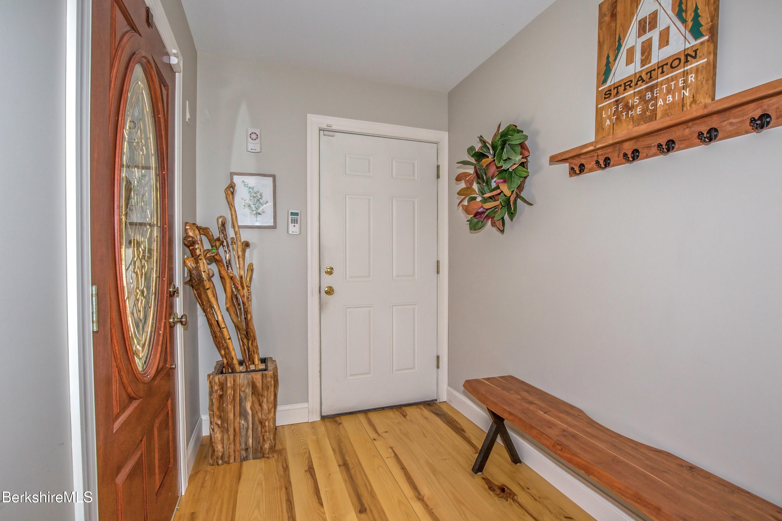 24 Evergreen Drive Otis, MA 01253 - Photo 10 of 41 a view of a hallway with wooden floor and stairs