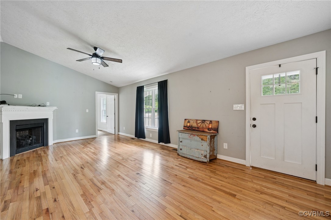 241 Deep Landing Road Tappahannock, VA 22560 - Photo 4 of 33 Unfurnished living room featuring light wood-style