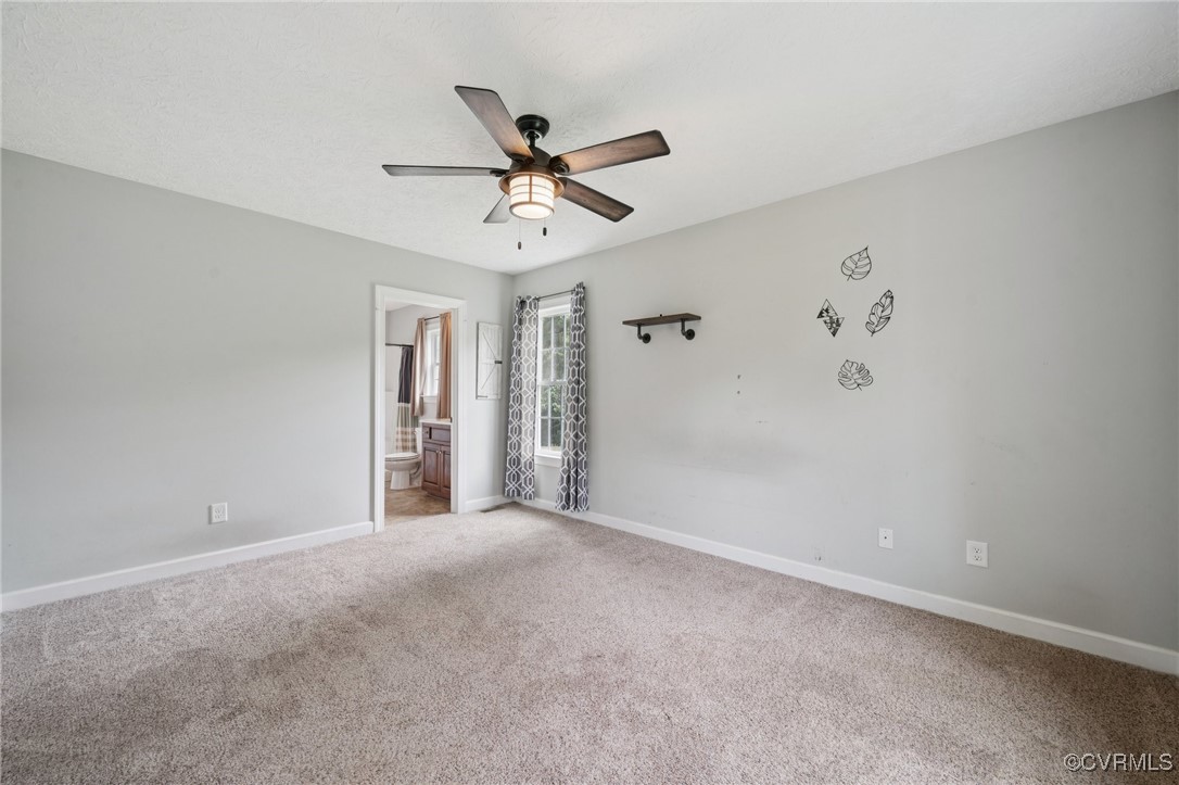 241 Deep Landing Road Tappahannock, VA 22560 - Photo 7 of 33 Carpeted spare room featuring a ceiling fan and ba