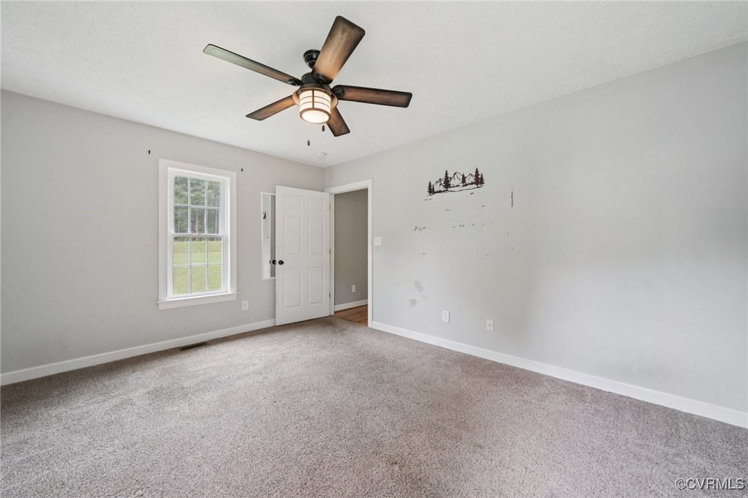 241 Deep Landing Road Tappahannock, VA 22560 - Photo 8 of 33 Spare room with carpet flooring, baseboards, and a