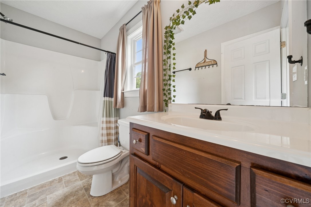 241 Deep Landing Road Tappahannock, VA 22560 - Photo 9 of 33 Bathroom with toilet, vanity, and a shower with sh