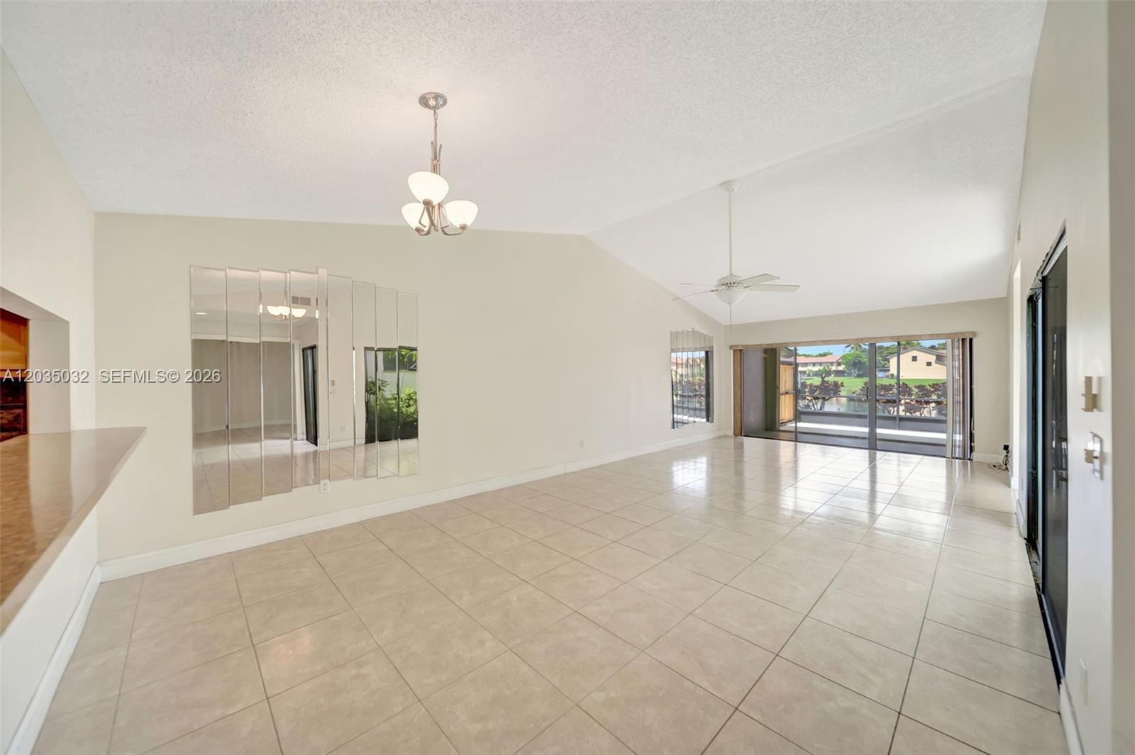 5223 Gate Lake Road, Unit 5223 Tamarac, FL 33319 - Photo 15 of 37 a view of an empty room with glass door and windows