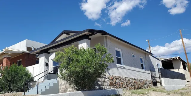 a view of a house with wooden fence