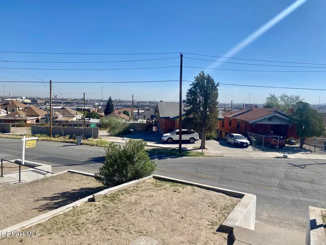 a view of a room with wooden floor and a window