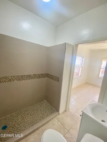 a bathroom with a glass shower door
